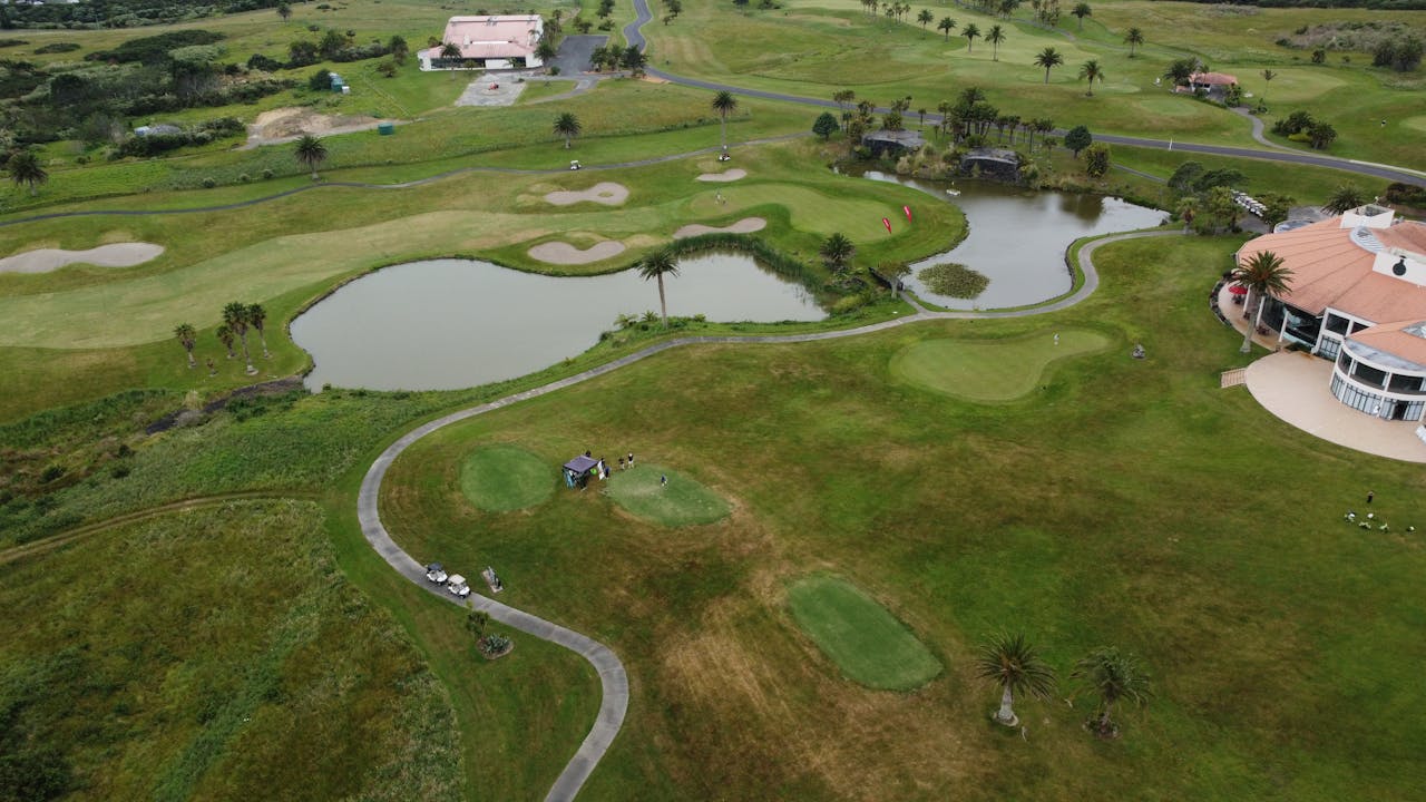 Scenic aerial image of a beautiful golf course in Auckland, New Zealand, ideal for sports and nature enthusiasts.
